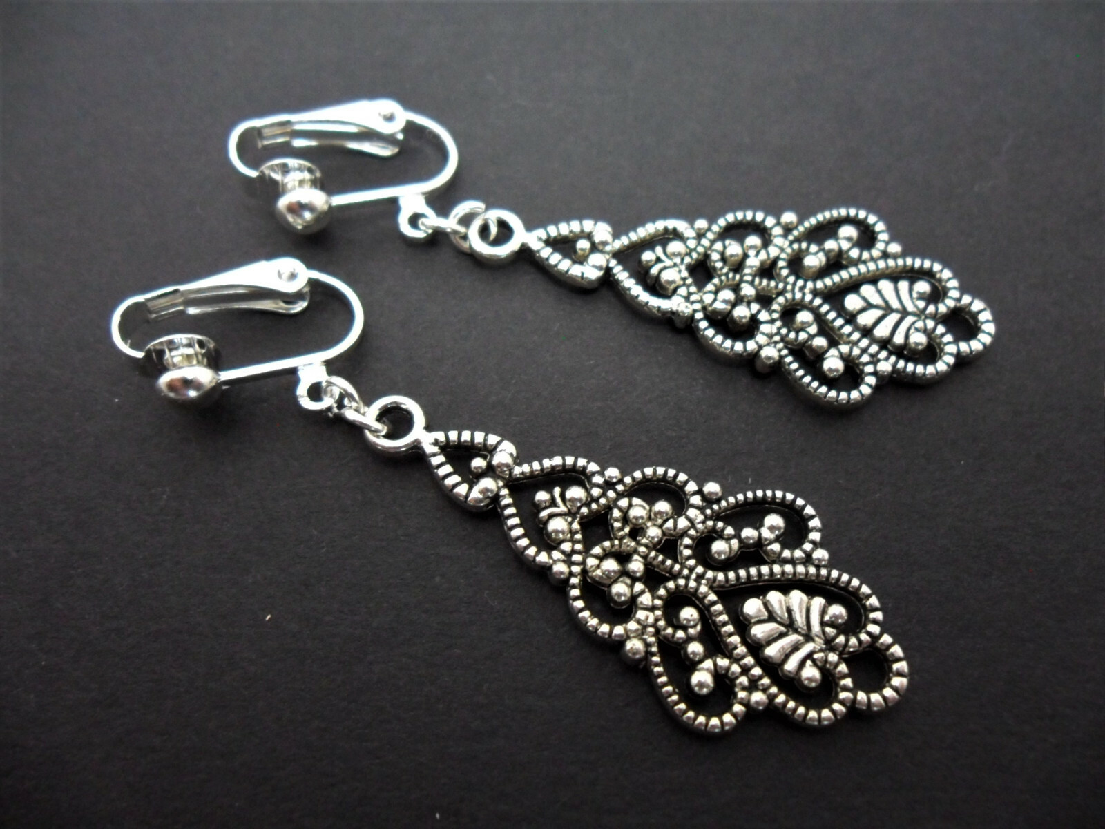 A PAIR OF TIBETAN SILVER DANGLY FILIGREE CLIP ON EARRINGS. NEW.
