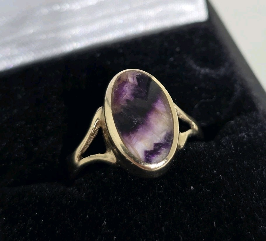 9ct Yellow gold open work ring. Collet set with an oval Blue John Cabochon.