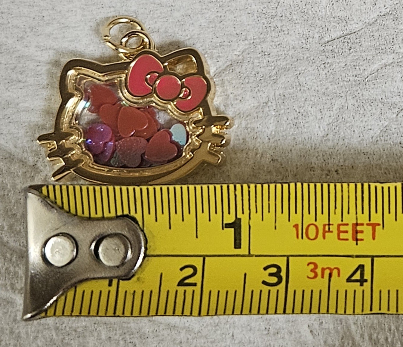 SANRIO HELLO KITTY GOLD TONE HEART CONFETTI SHAKING GLASS PENDANT CHARM