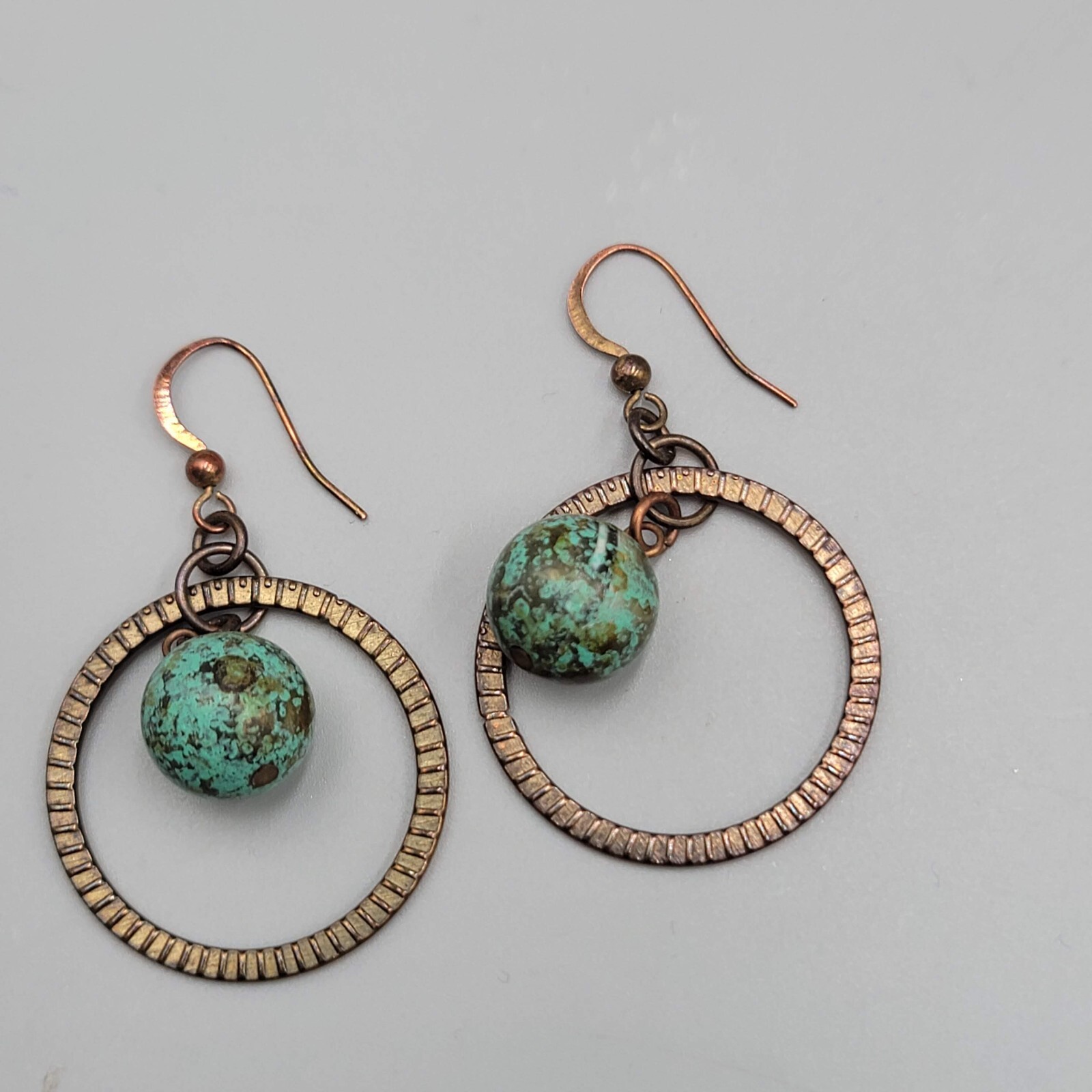 Bronze tone Dangle Pierced Earrings Green Bead Center Dangle 1.5″