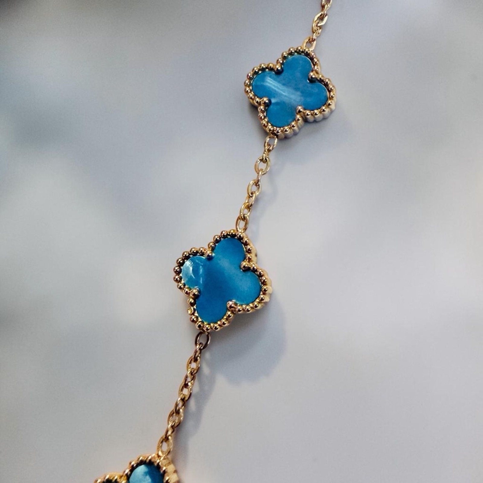 Iridescent Blue Clover Station Bracelet in Gold Tone