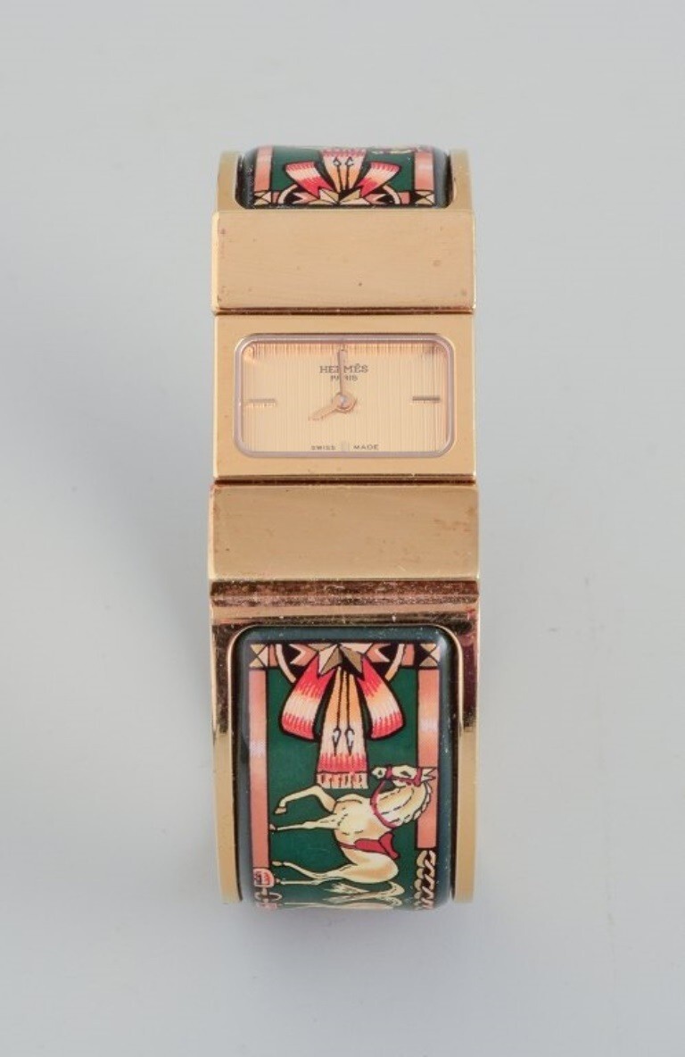 Hermes, ladies’ wristwatch. Made of gilded metal and enamel work.