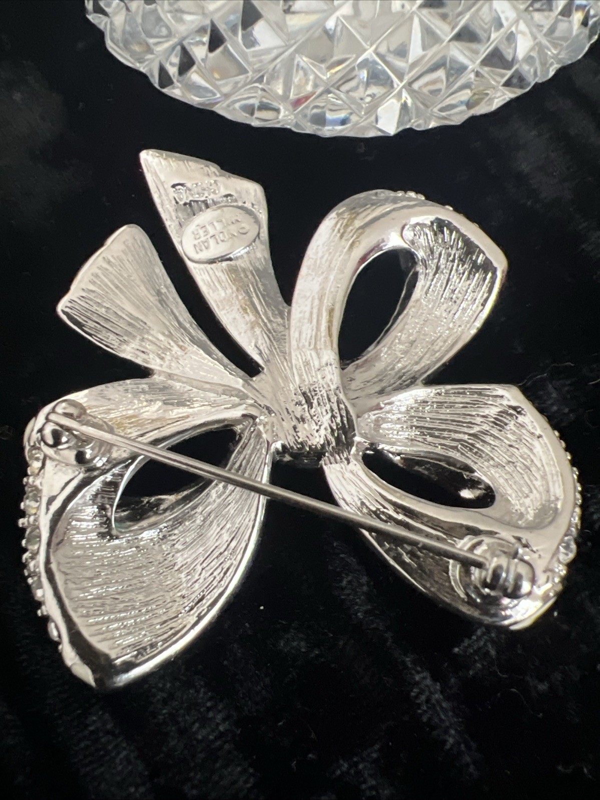 item is a Nolan Miller Shining Spirit rhinestone bow brooch from the Glamour CO.