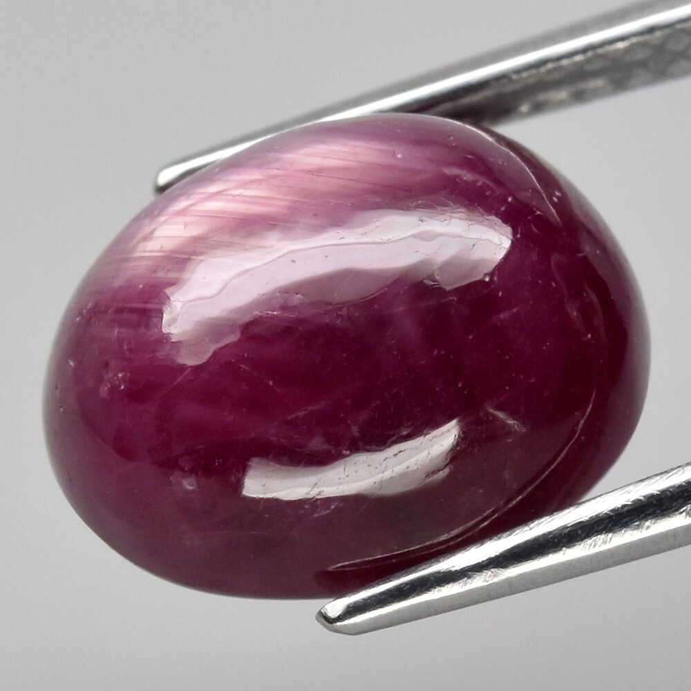 9.05ct 12×9.8mm Oval Cab Purplish Red 6 Ray Star Ruby (Heated Glass Filling)