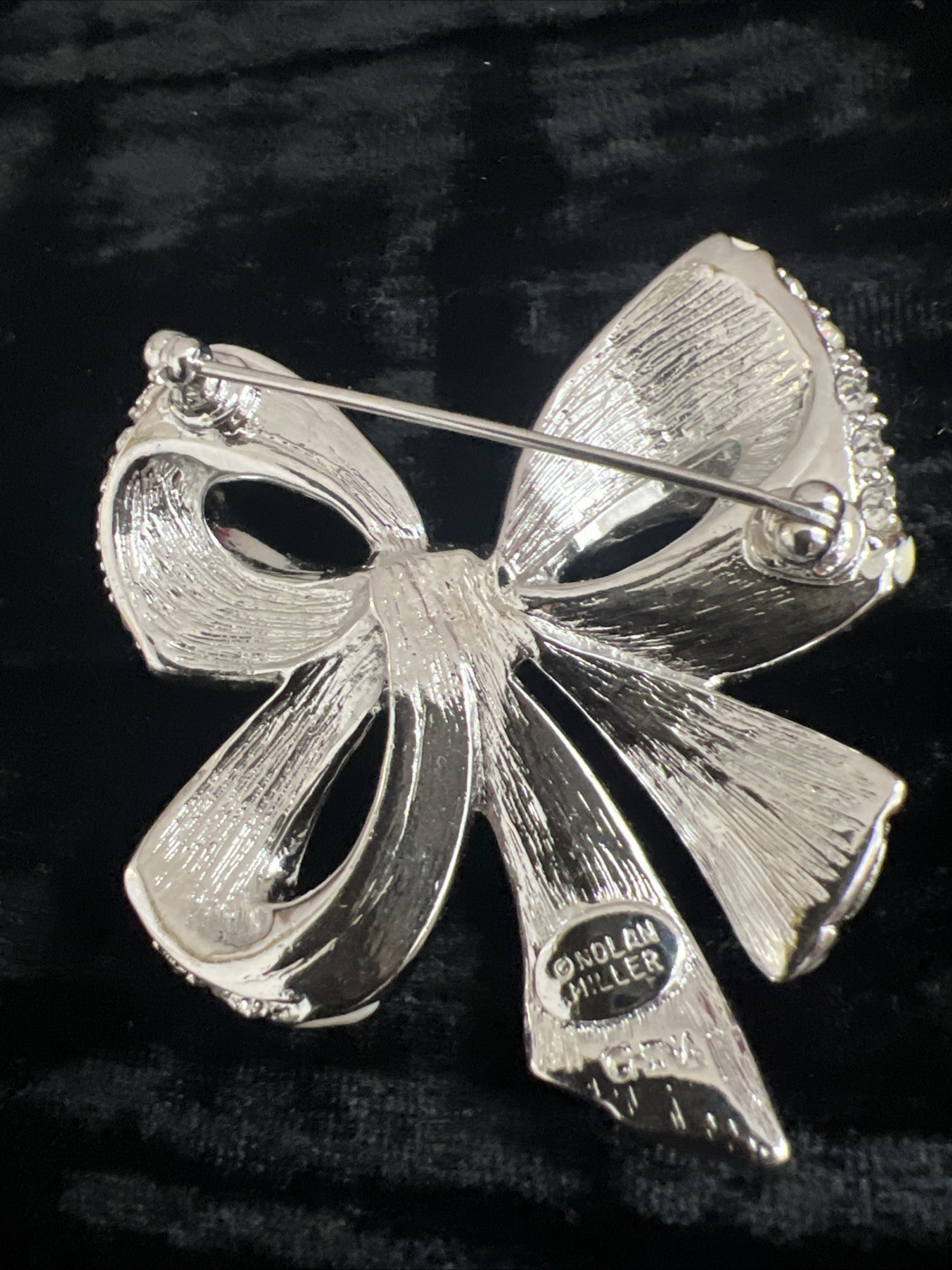 item is a Nolan Miller Shining Spirit rhinestone bow brooch from the Glamour CO.