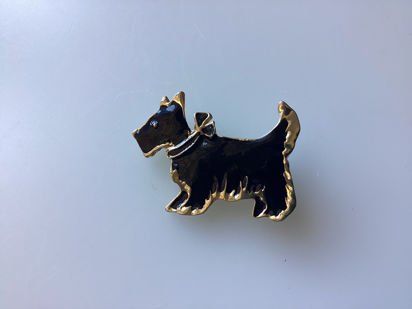 AN ATTRACTIVE BLACK AND GOLD TONED ENAMEL PIN BROOCH FEATURING S SCOTTIE DOG