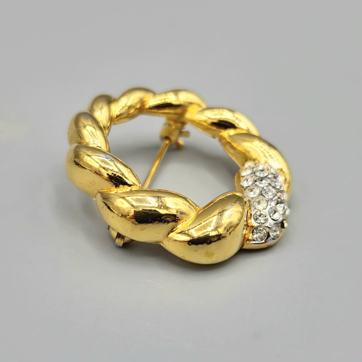 Crown Trifari Polished Gold Tone Crystal Pave Open Circle Twist Brooch
