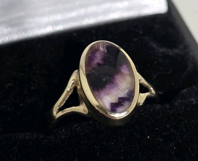 9ct Yellow gold open work ring. Collet set with an oval Blue John Cabochon.