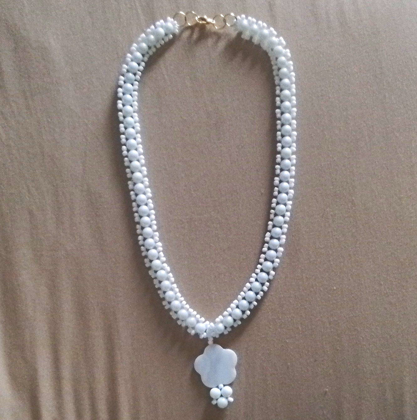 White shell beads, crystals, and small seed beads; necklace with a flower pendan