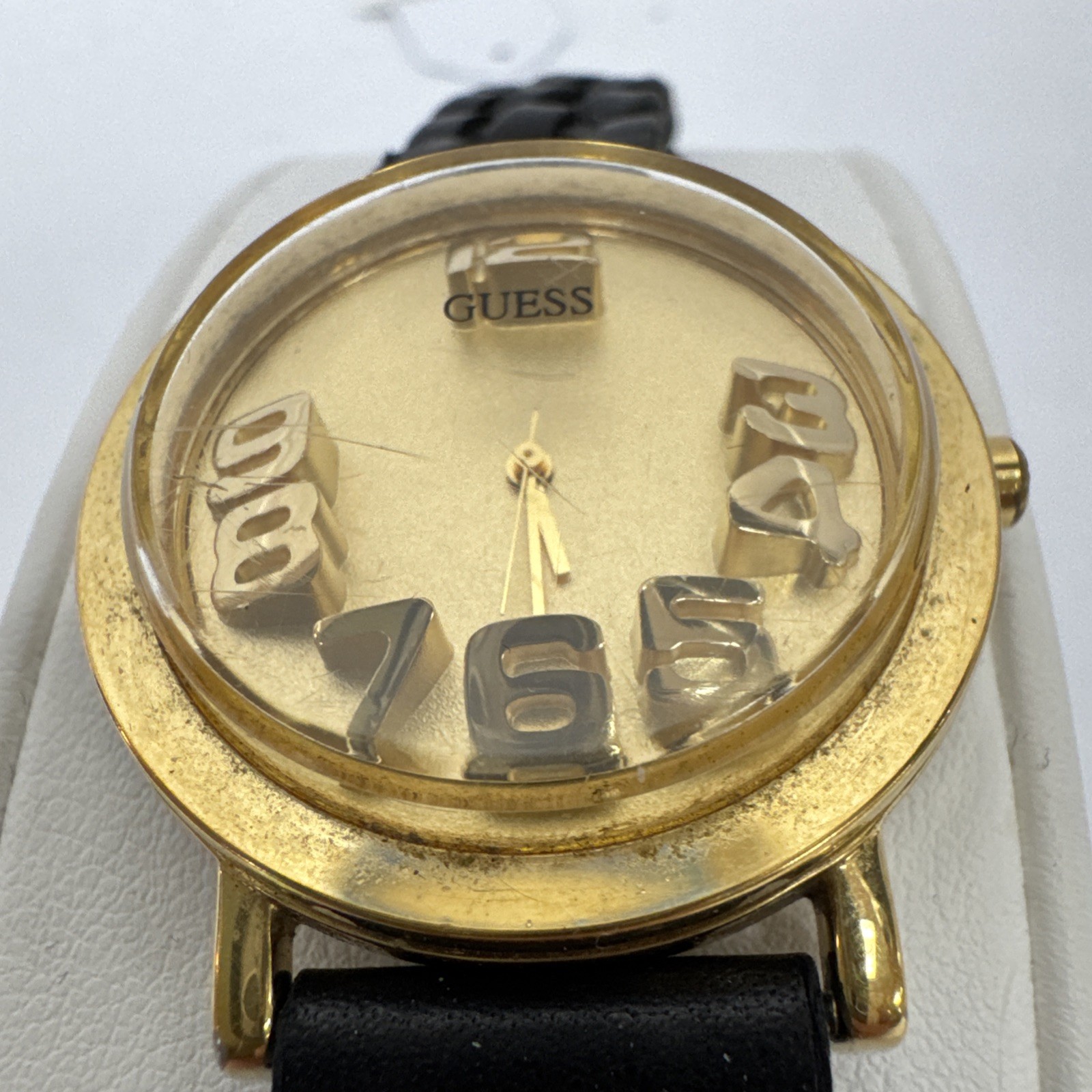 Vtg Guess watch gold-tone & raised 3D numbers and a black braided leather band.