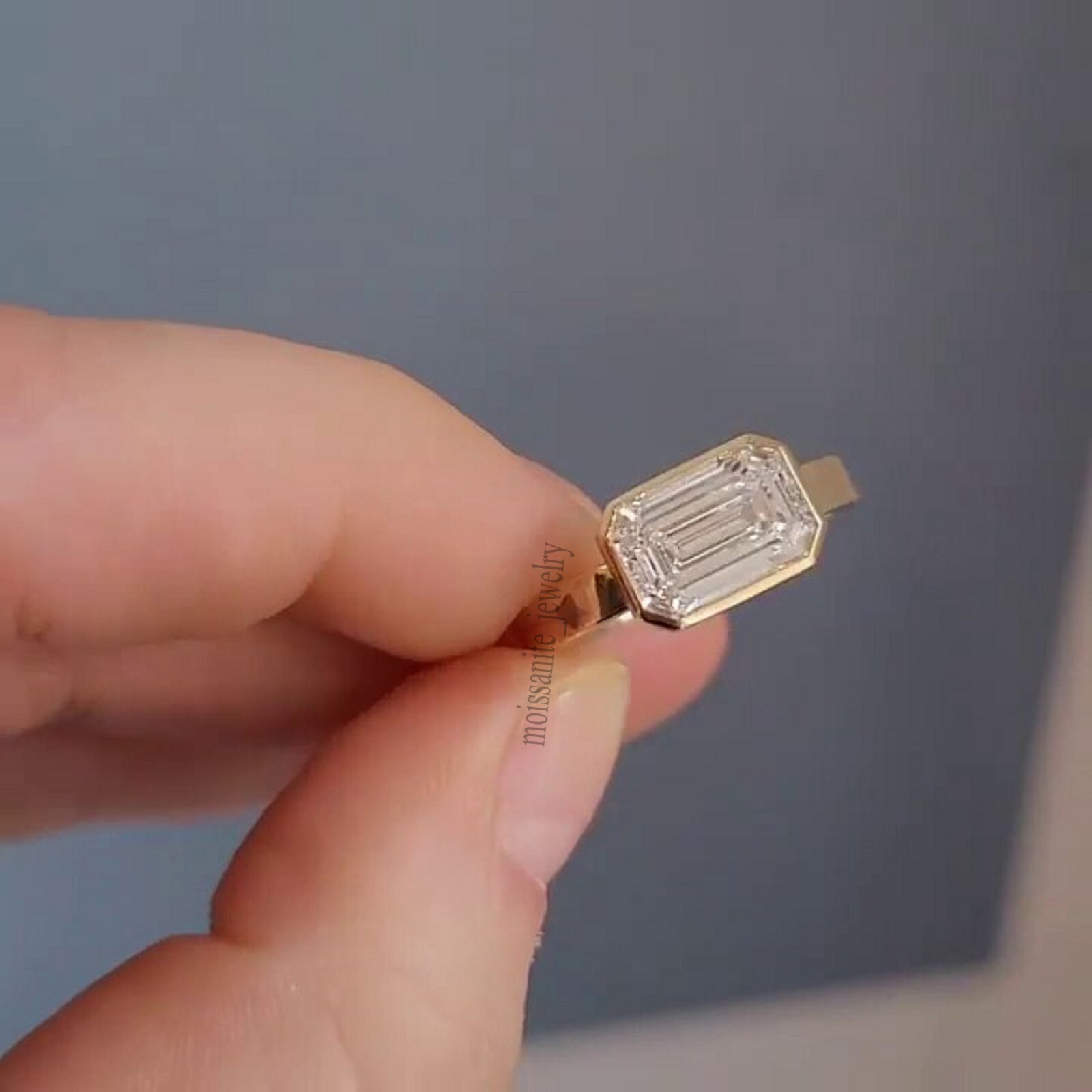 East West Bezel Set 1.70 Carat Emerald Cut White Moissanite Ring 10k Yellow Gold