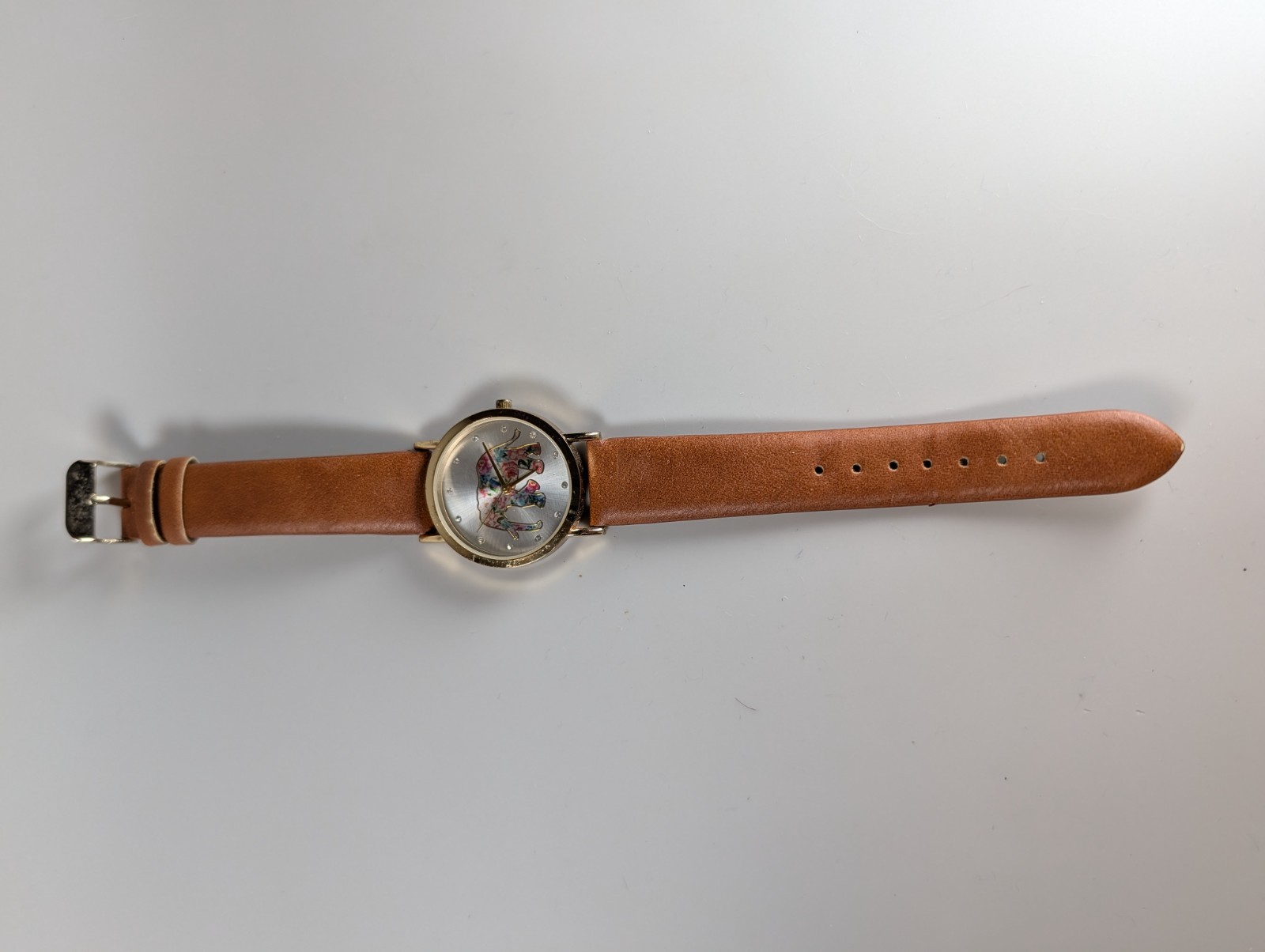 Elephant watch with flower pattern and gold outline and dot indexes brown band