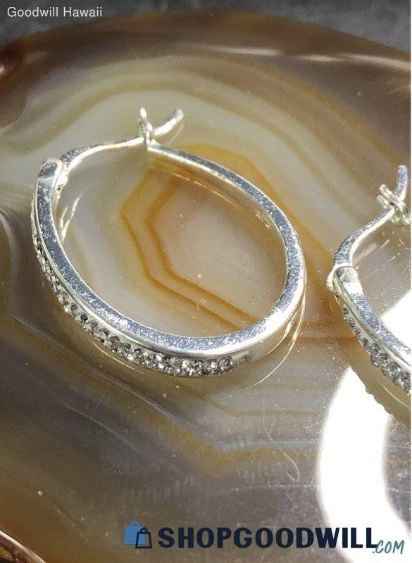 classic oval hoop earrings feature a polished silver-tone finish accented by a