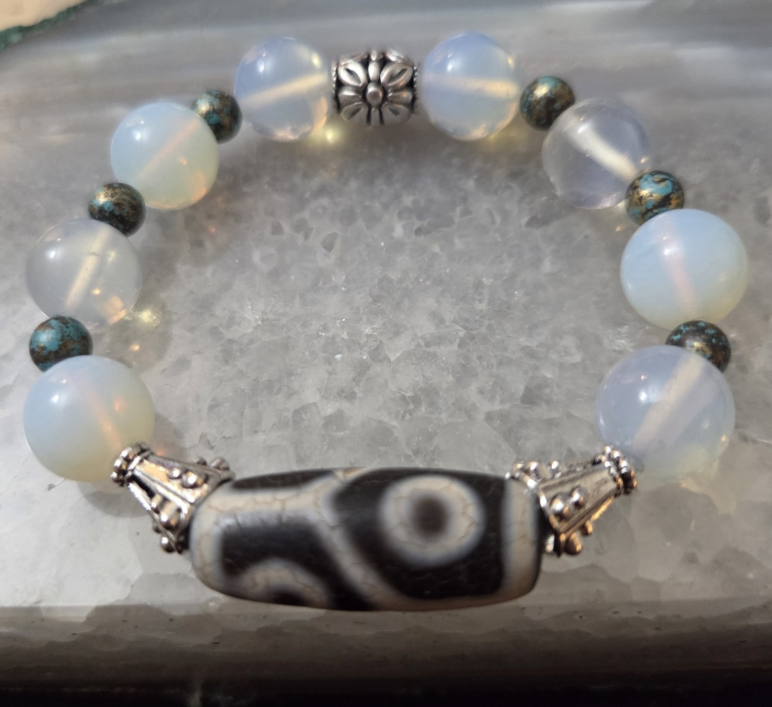 Women’s bracelet featuring a Tibetan 4-eyed Dzi bead paired with Opalite.