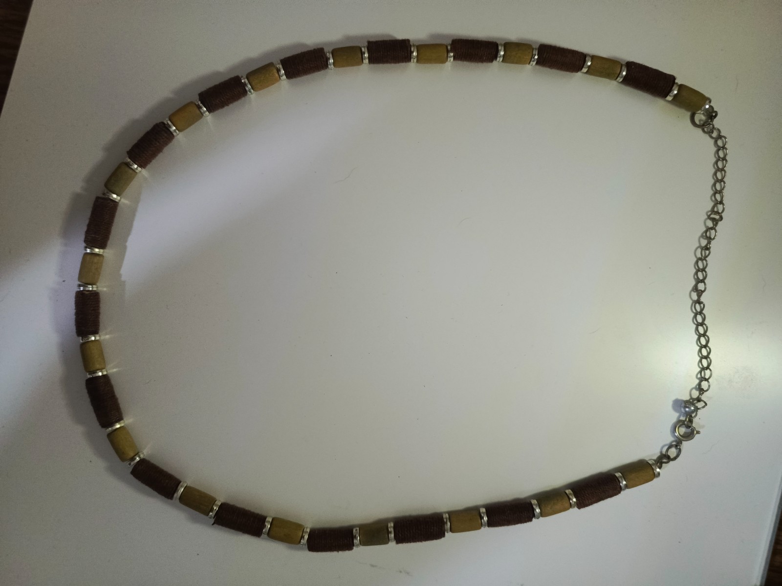 necklace features Polaris barrels in brown and beige separated by small gold-col