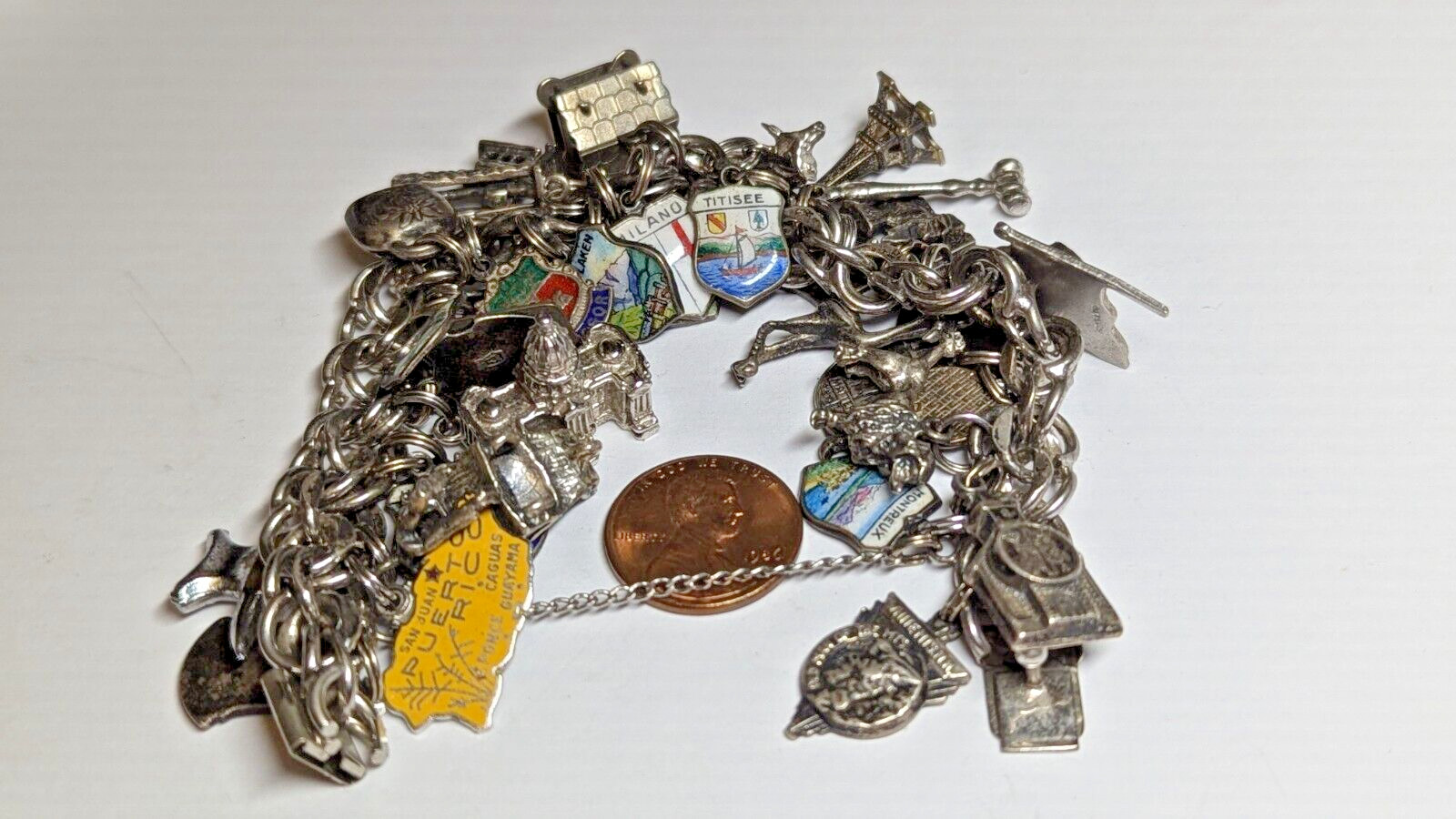 VINTAGE STERLING SILVER CHARM BRACELET WITH ABOUT 35 CHARMS WEIGHS 94.4 GRAMS