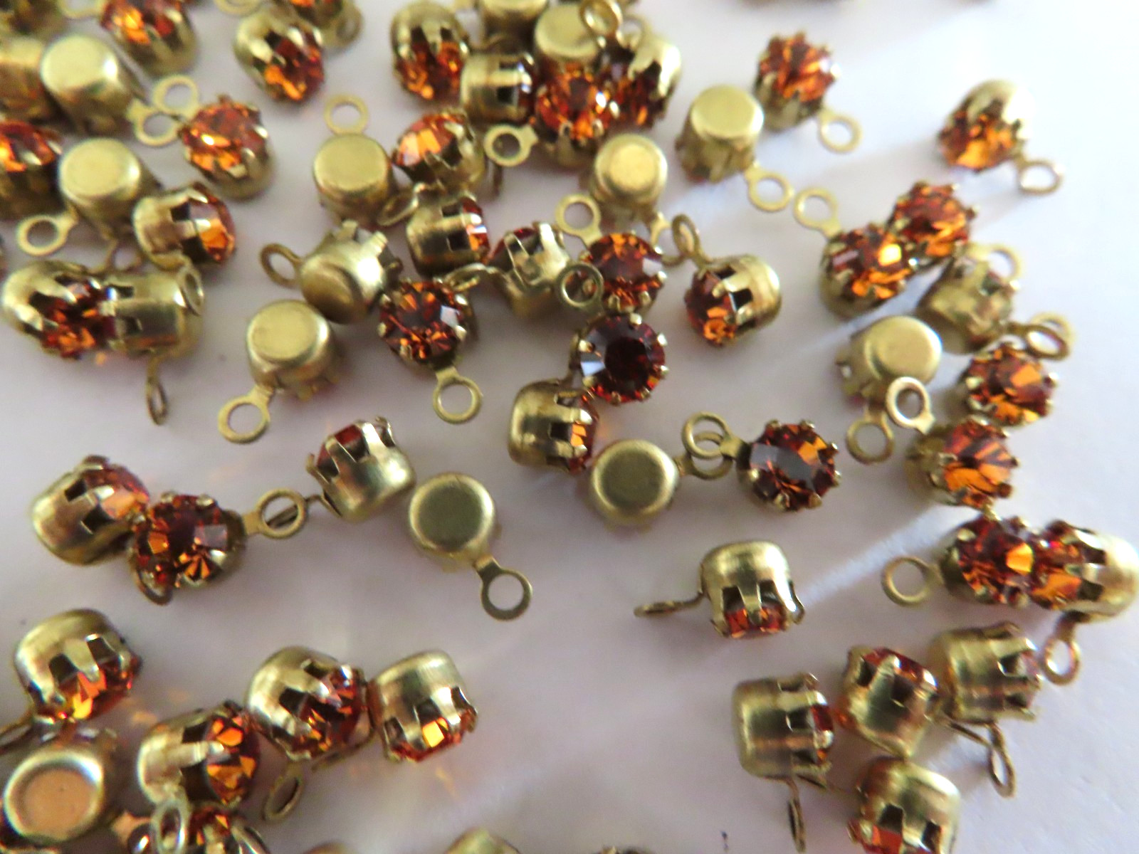 72 Swarovski Rhinestones 32pp Topaz/ 1-loop brass tiffany settings.