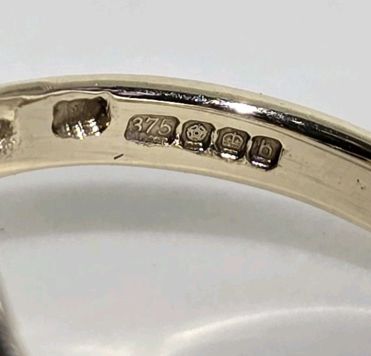 9ct Yellow gold open work ring. Collet set with an oval Blue John Cabochon.