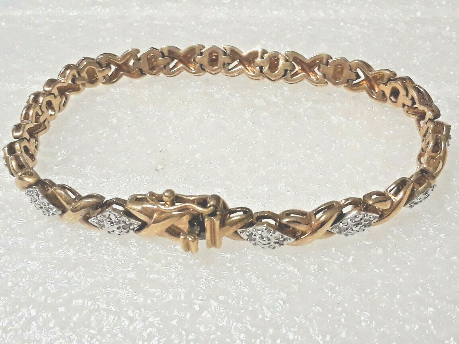 Gold tone bracelet with clear stones and safety lock clasp. 7″ long. Beautiful!