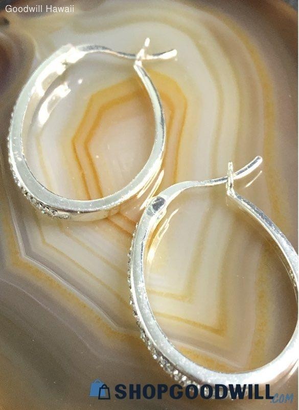 classic oval hoop earrings feature a polished silver-tone finish accented by a