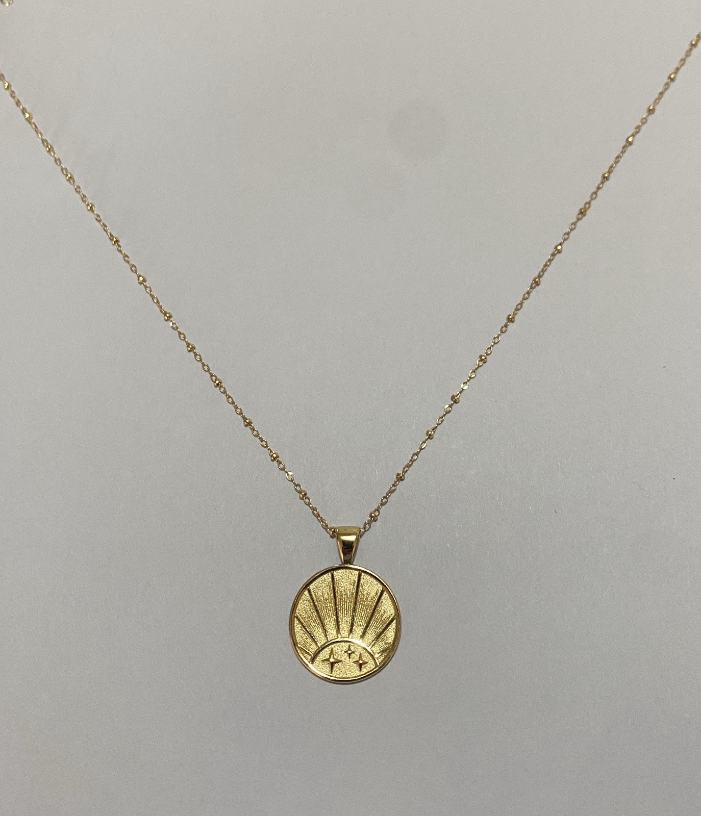 Jane Win Small “Strong” pendant with bead chain.