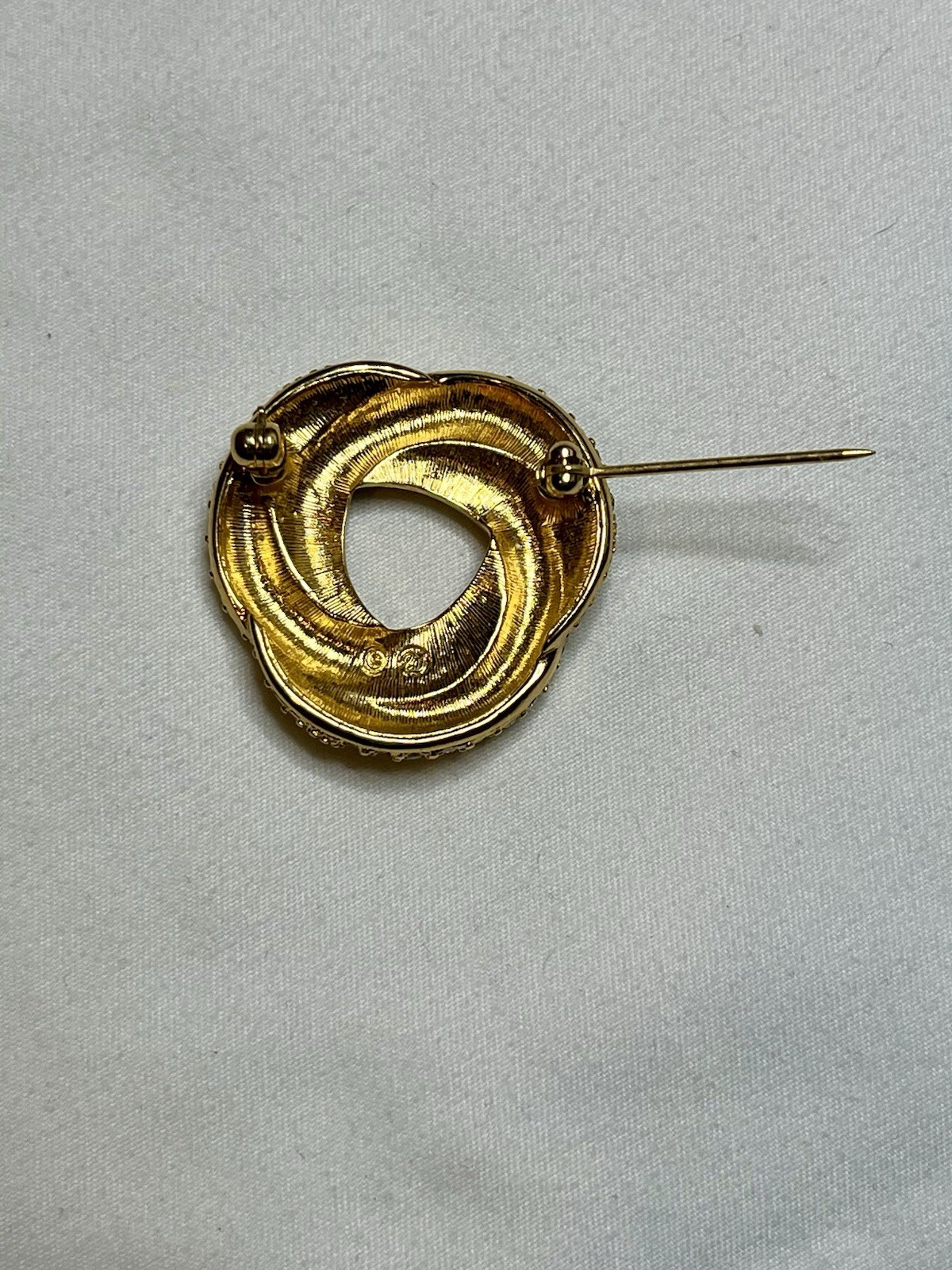Signed Swarovski Gold Tone Clear Crystal Black Enamel Love Knot Brooch Pin