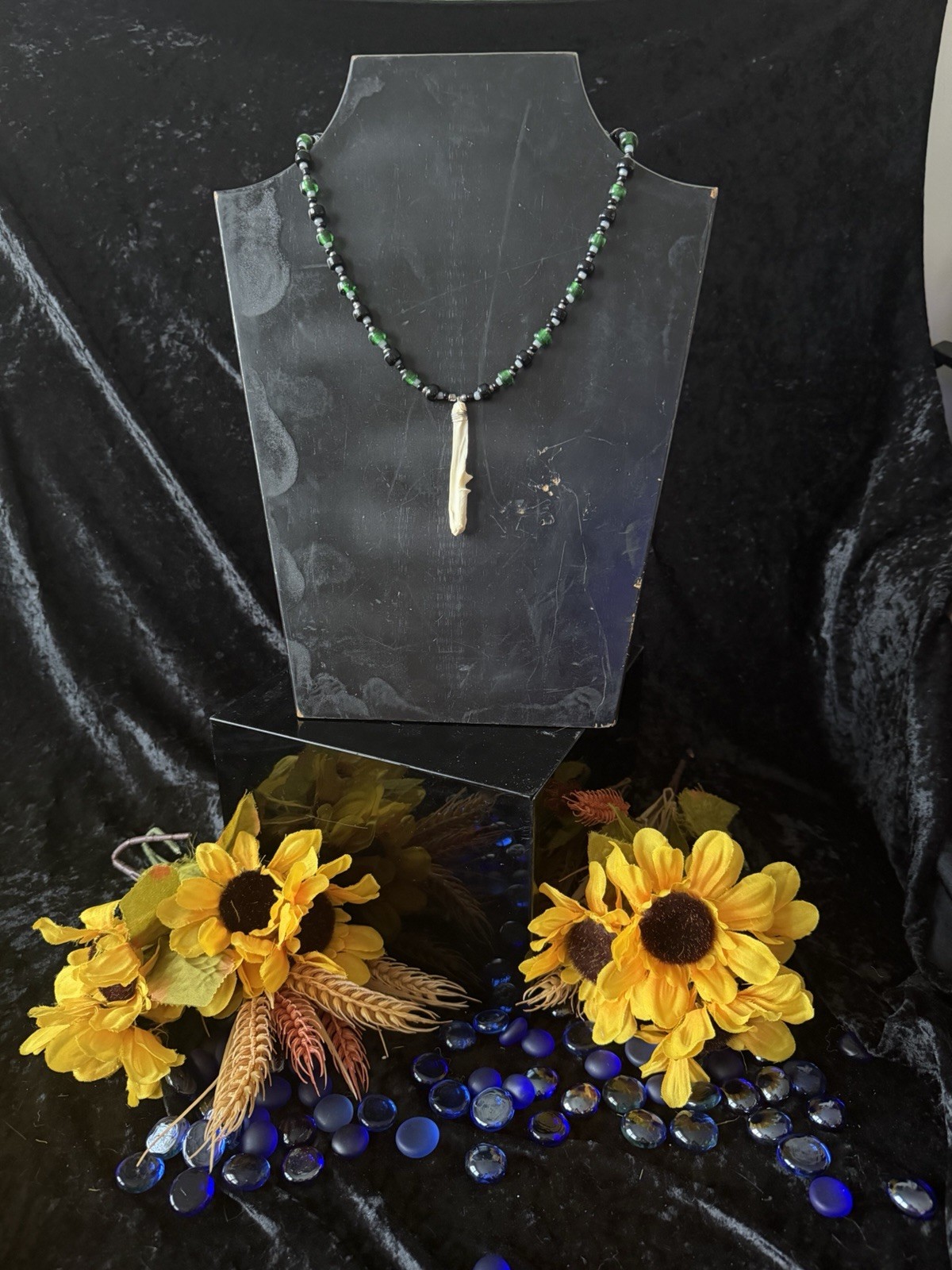 Armadillo leg bone necklace with green, black, gray, and silver glass beads