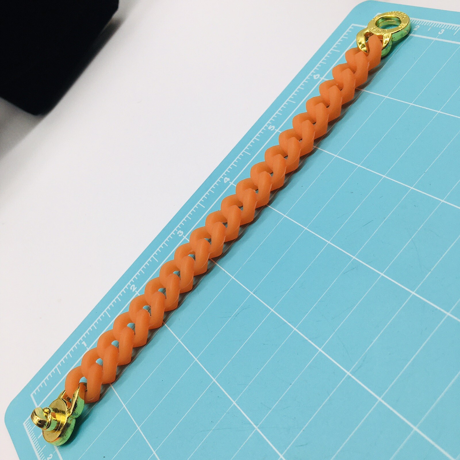 Rustic Cuff Gold Tone Logo Turn Lock Orange Silicone Stretch Mock Chain Bracelet