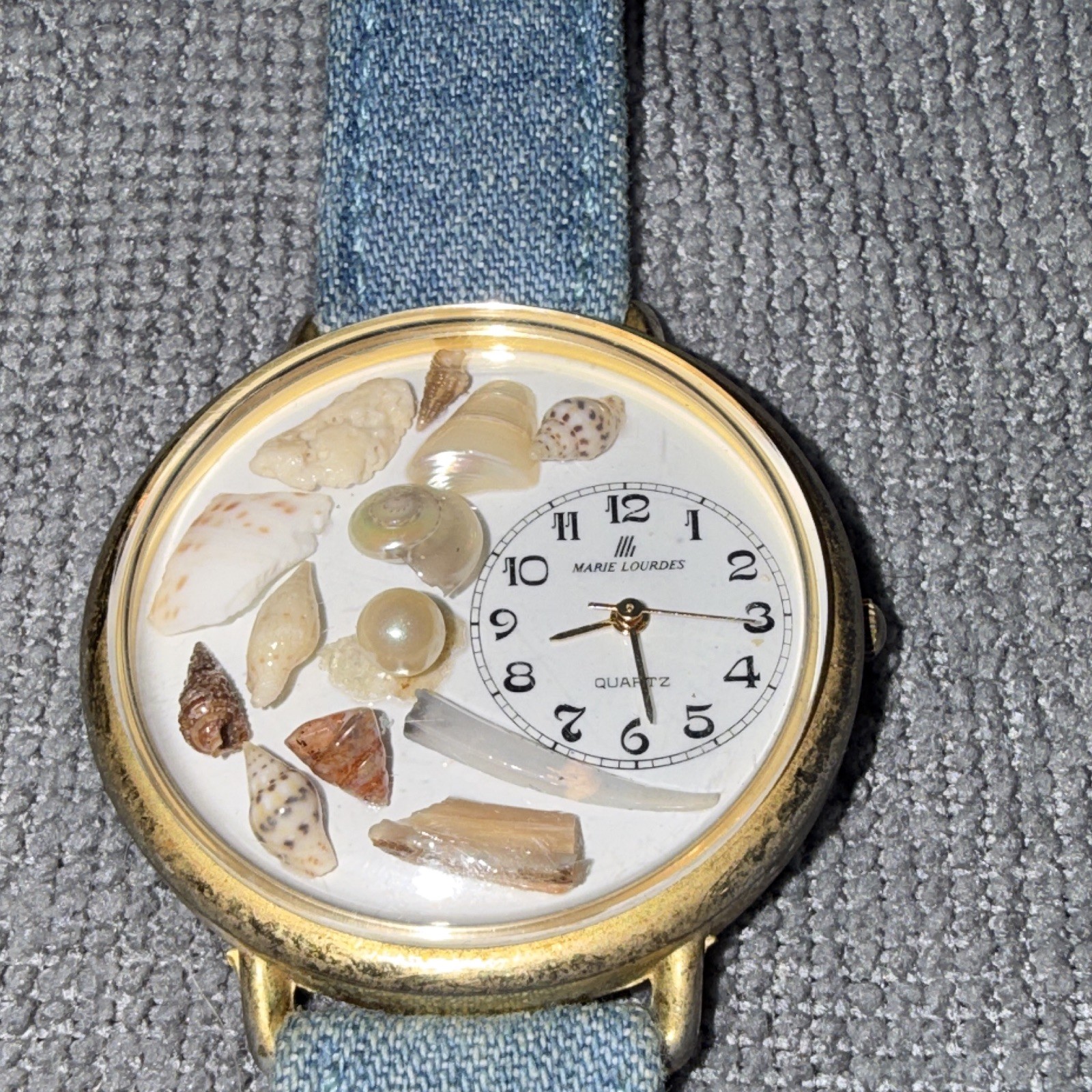 Marie Lourdes Quartz Women’s Analog Watch Seashell Dial Gold Tone Blue Strap