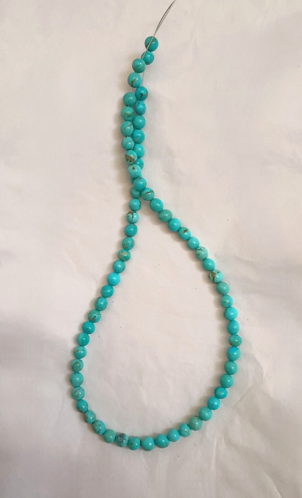 OLD STOCK KINGMAN TURQUOISE 5.7-6MM OFF-ROUND BEADS – 15.75″ – 5743E