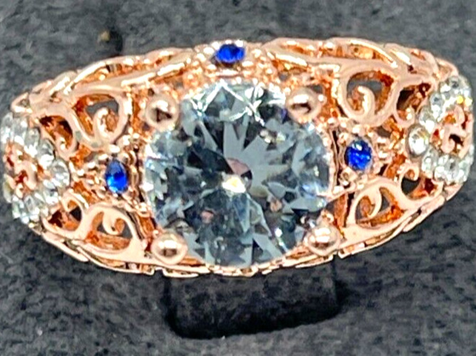 Ring Rose Gold Clear Center Crystal, Clear & Blue small crystal accents. Sz 6
