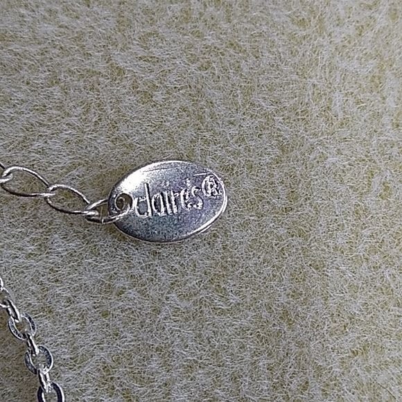 Claire’s silvertone multi-strand necklace with pink flower pendant