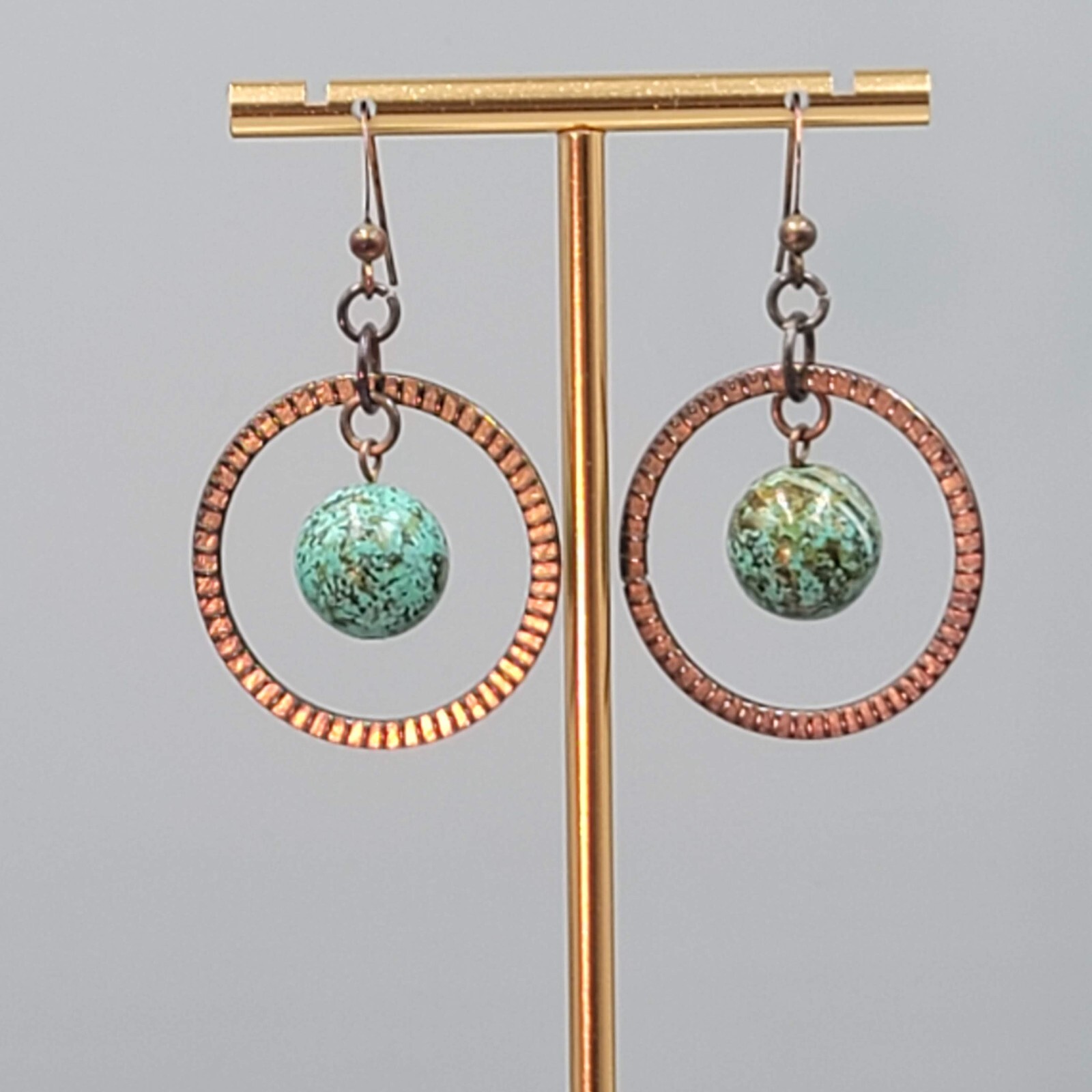 Bronze tone Dangle Pierced Earrings Green Bead Center Dangle 1.5″