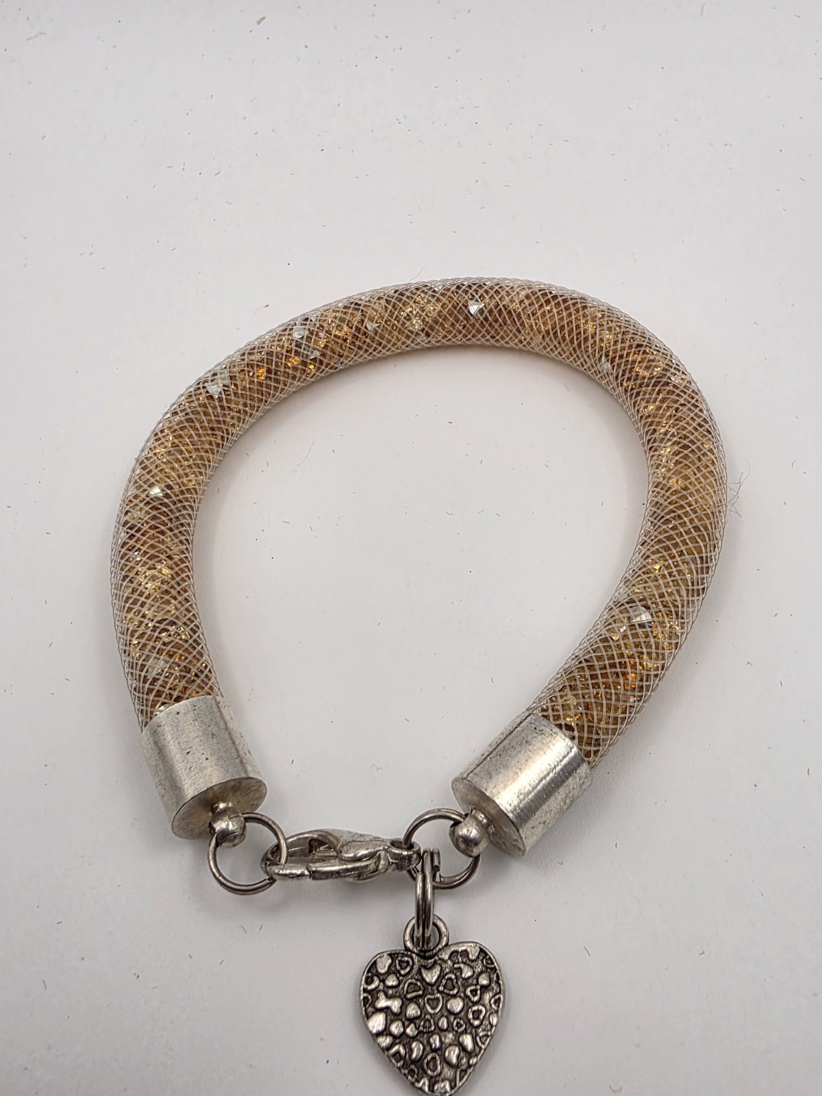 Gold Tone Tubular Mesh Bangle With Crystals And Heart Charm