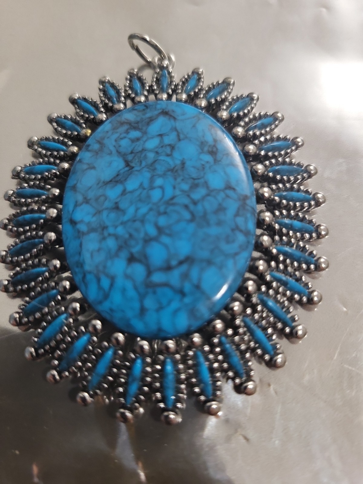 2 Faux Turquoise silvertone pendants. lg one is marked JJ both great pieces