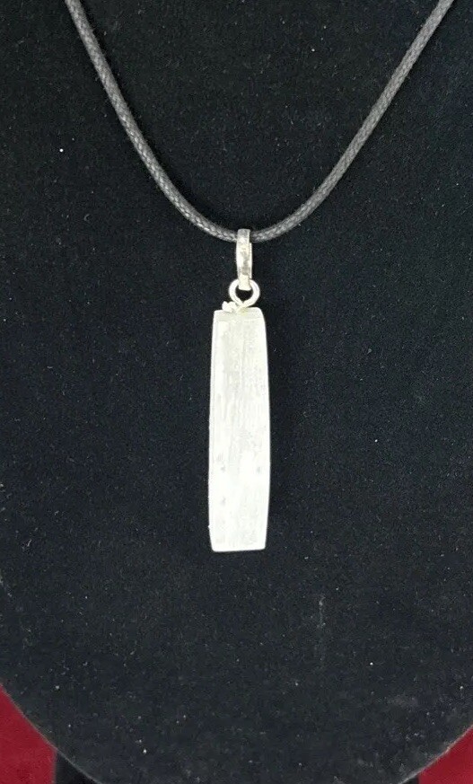 Selenite top drilled pendant with silver colored bail and adjustable cord