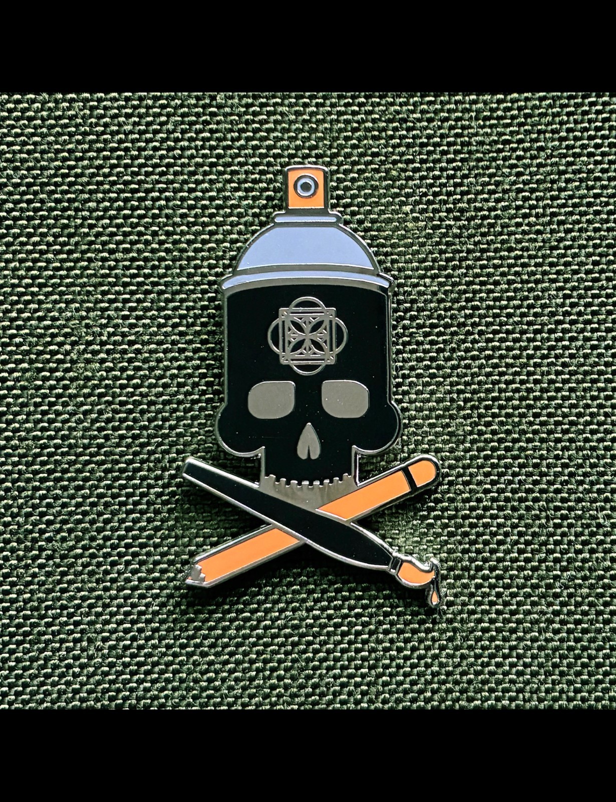 Crossbrushes 1.25″ black orange grey nickel enamel pin with single clasp