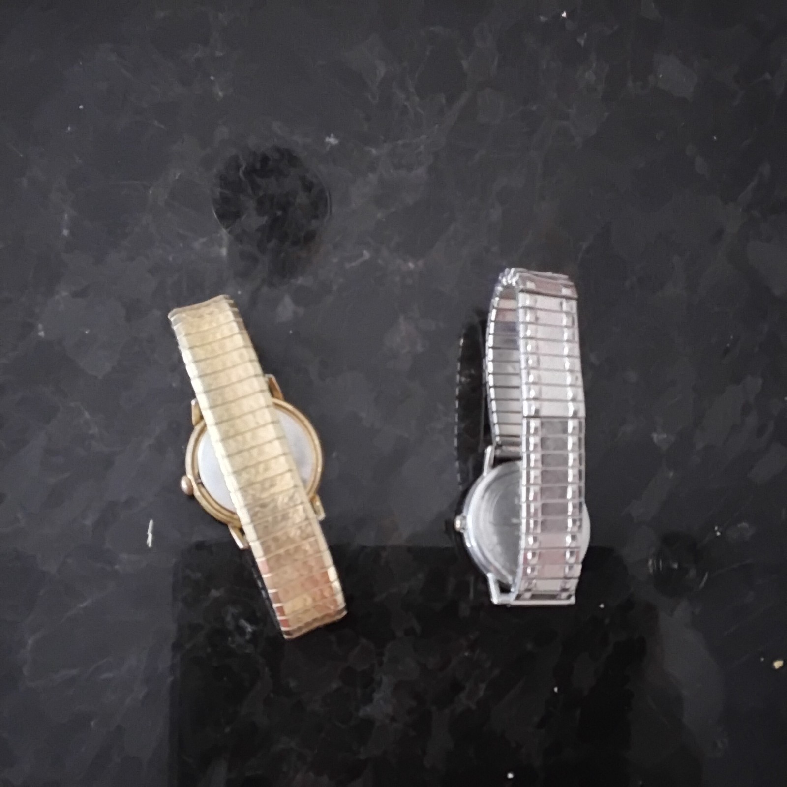 a silver 2016 timex watch and a bronze timex watch