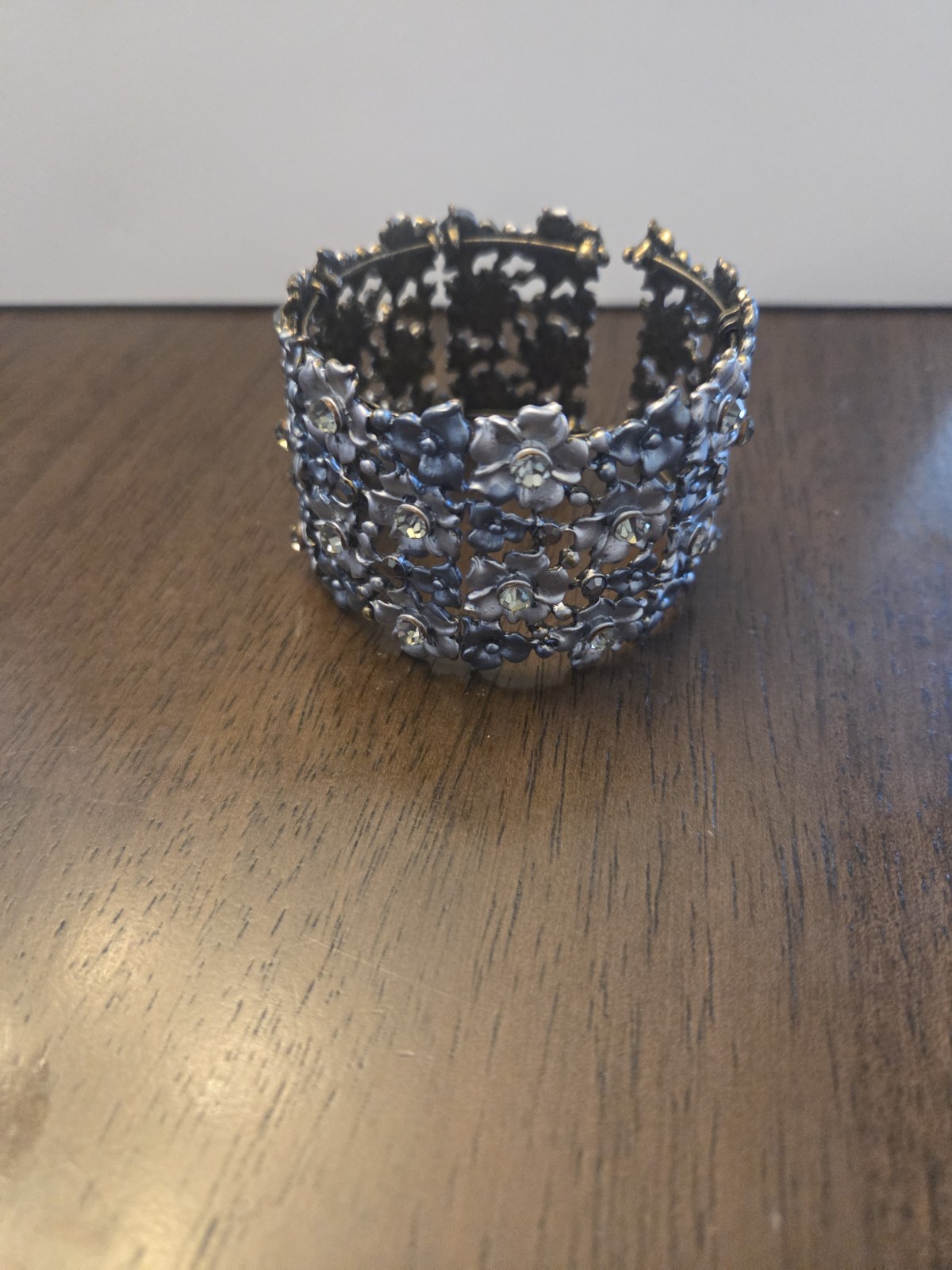 Silver 8 Inch. Metal Stretch Bracelet With Floral Design And Crystal Accents