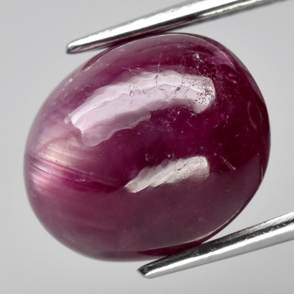 9.05ct 12×9.8mm Oval Cab Purplish Red 6 Ray Star Ruby (Heated Glass Filling)