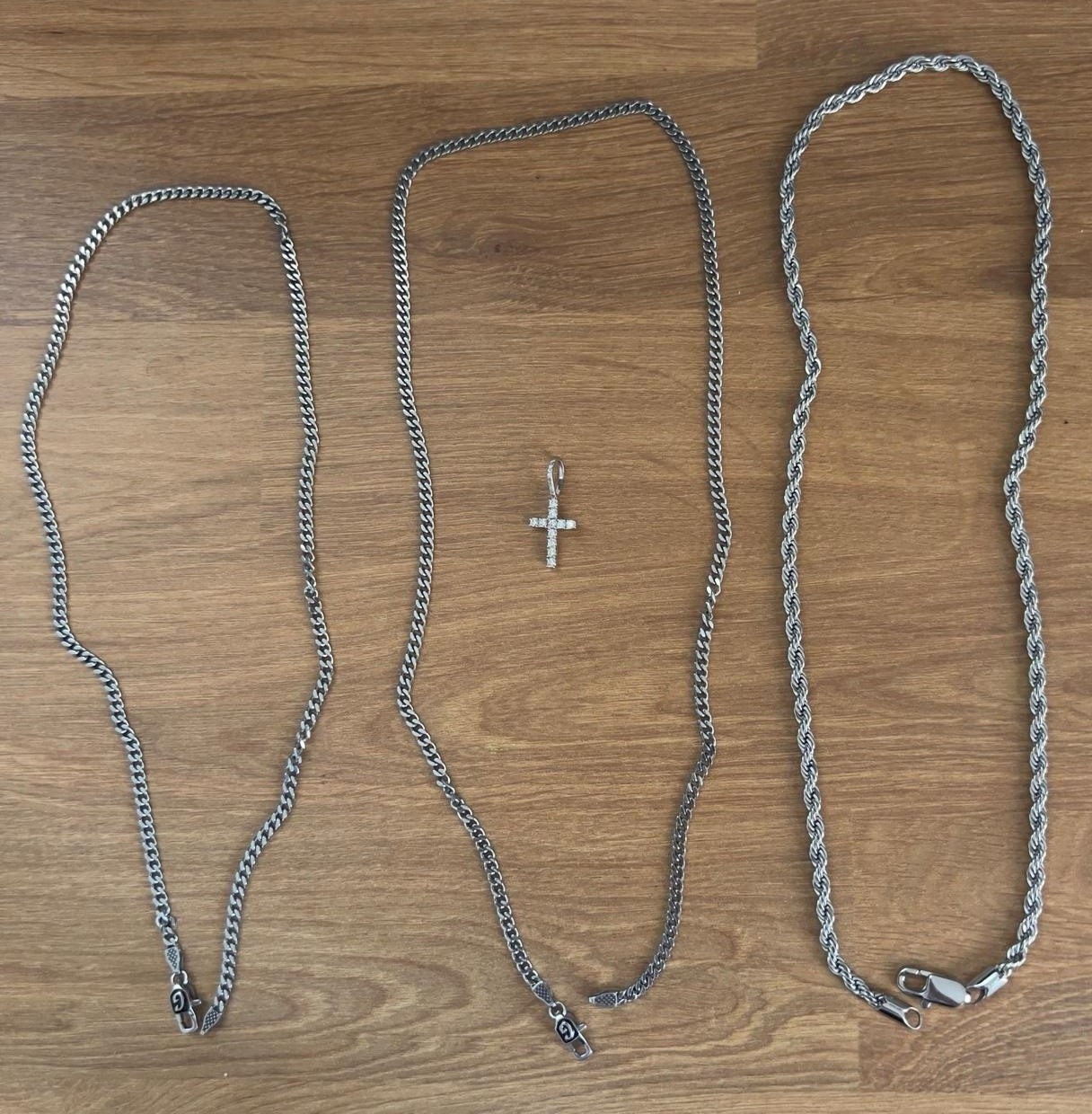 Silver “GLD” chains with a cross style pendant. All brand new