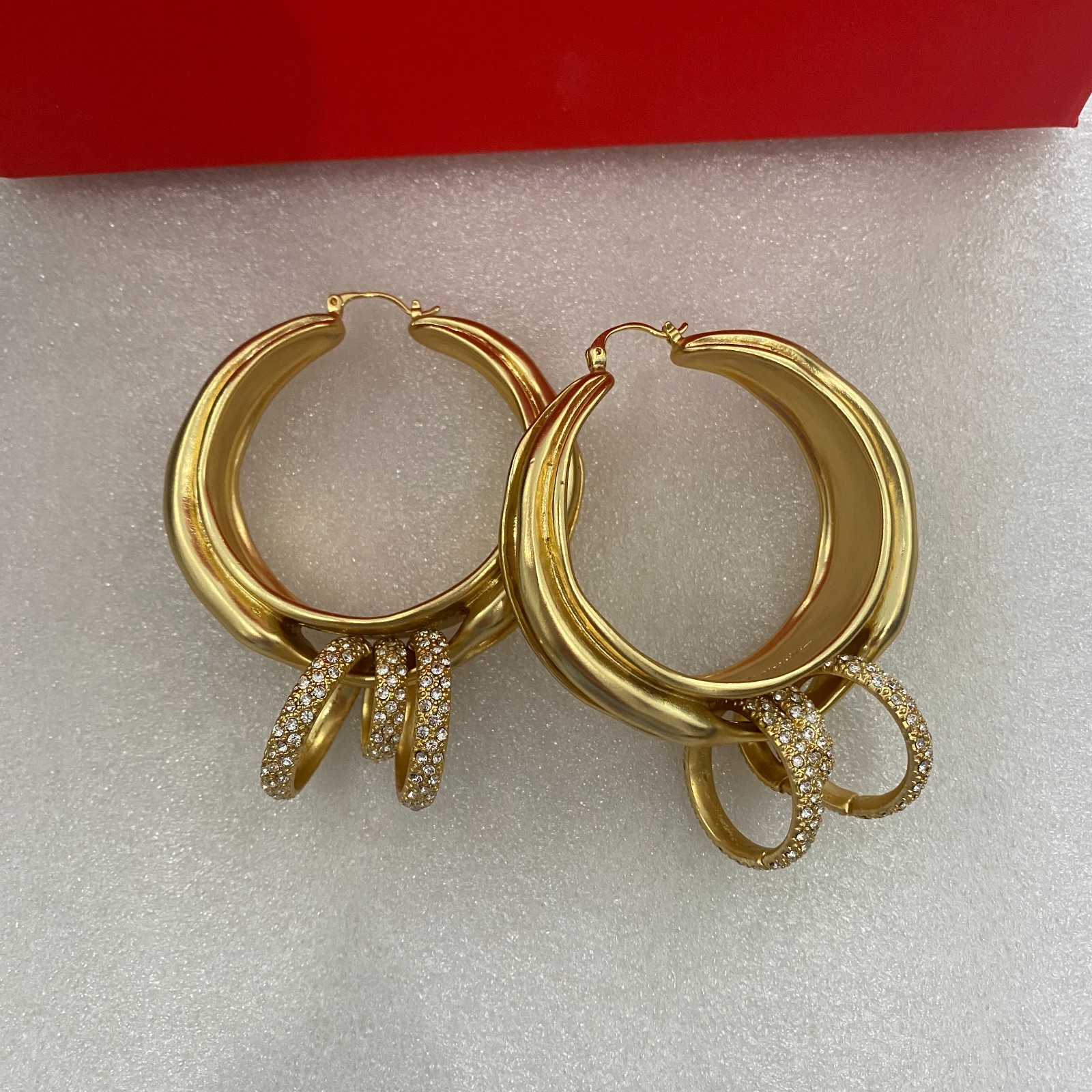 Schiaparelli Asymmetrical Twisted Gold Hoop Earrings With Pave Crystal Rings