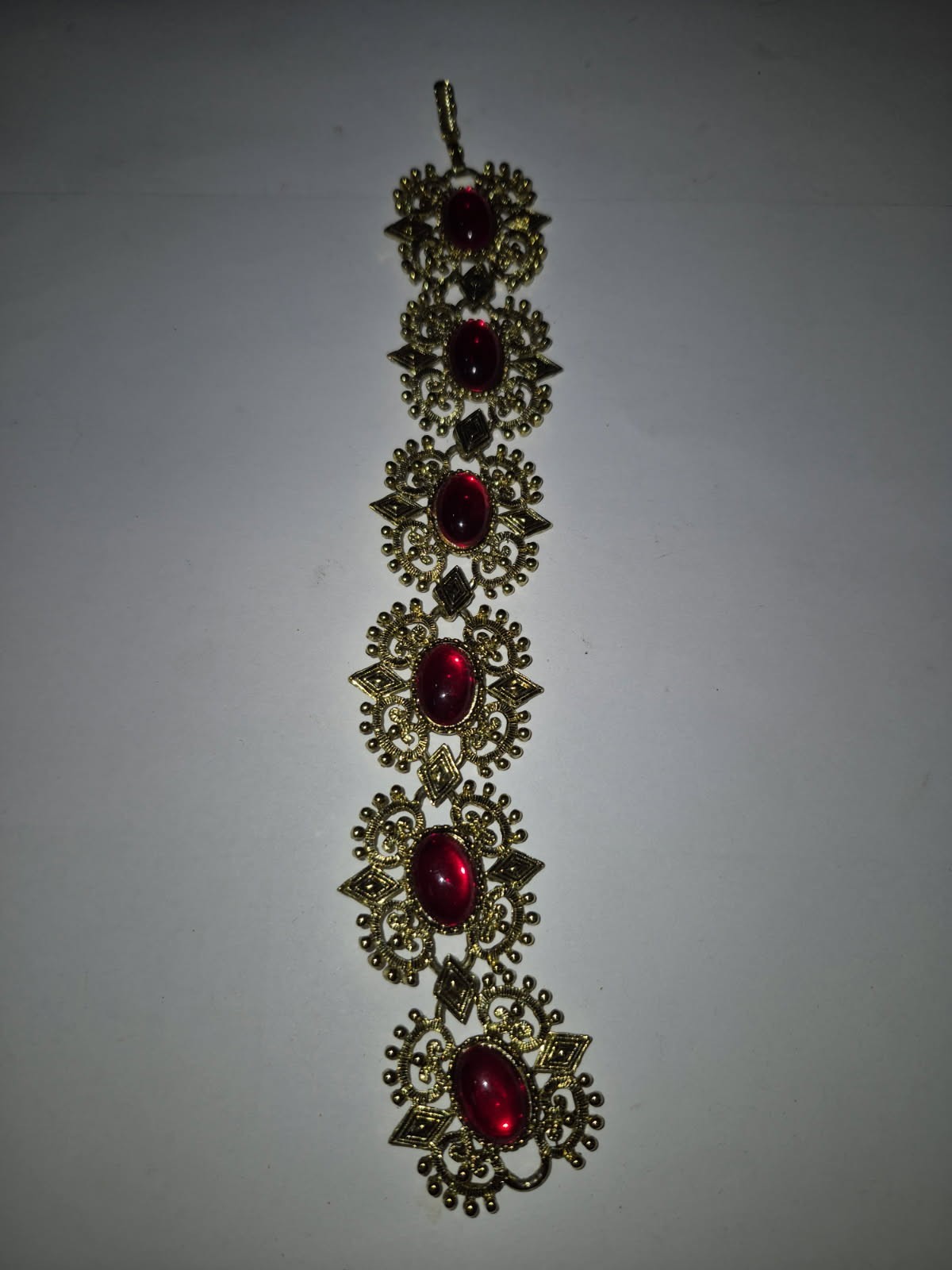 Vintage ornate gold tone panel link red glass cabochon bracelet, unsigned TT8