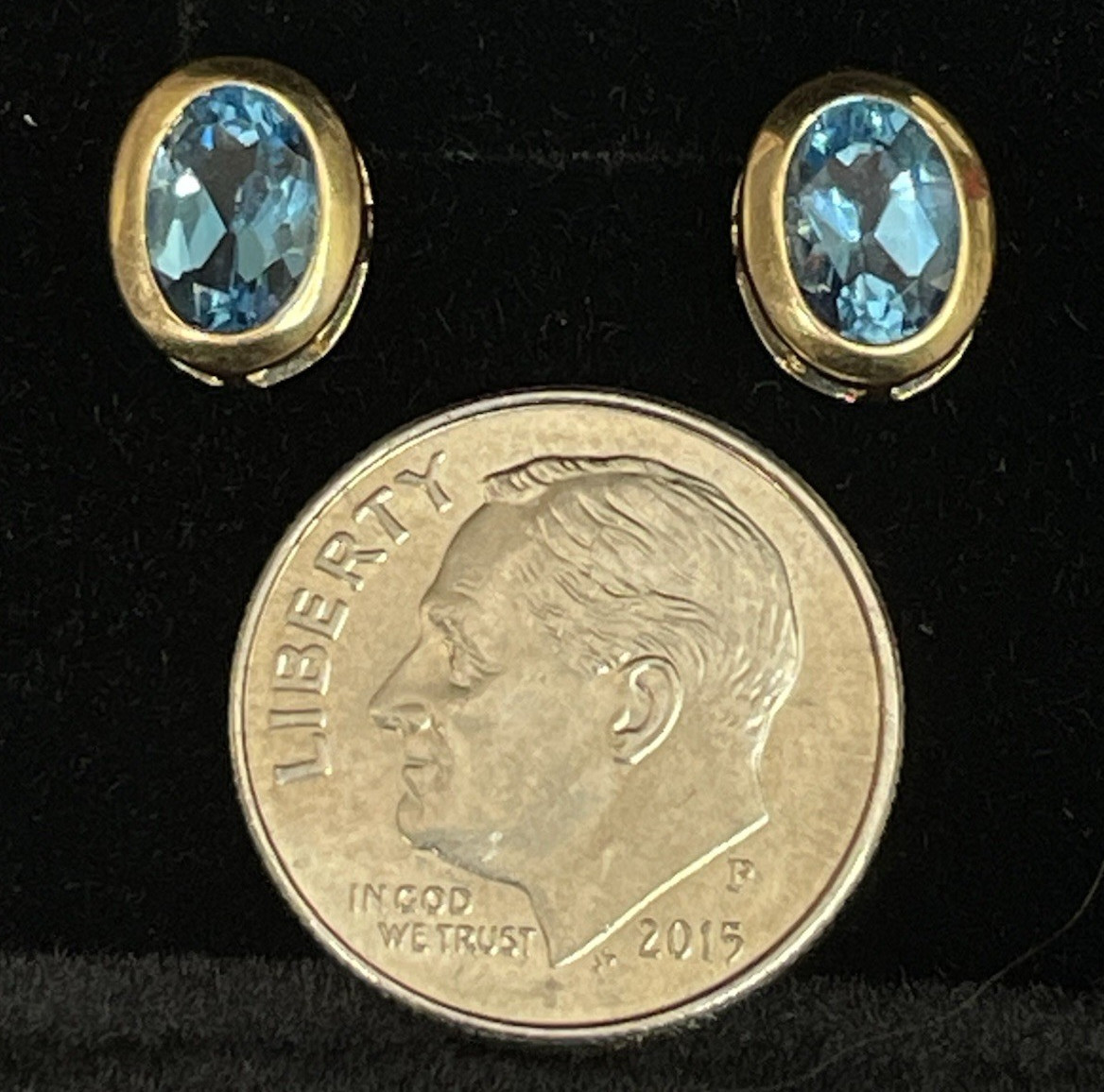 14k yellow gold oval blue topaz stud earrings. no clutch