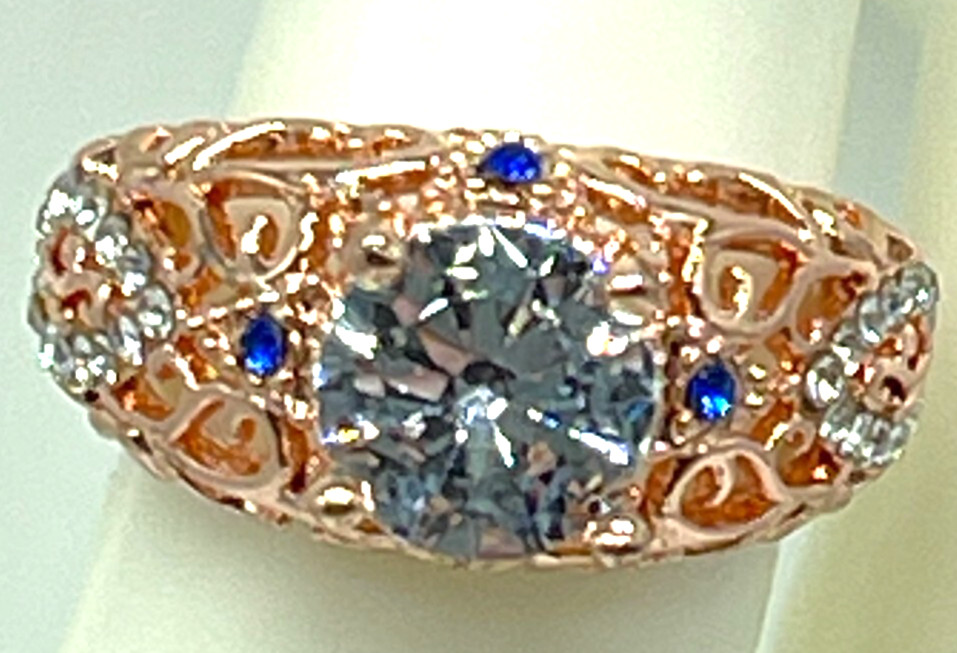 Ring Rose Gold Clear Center Crystal, Clear & Blue small crystal accents. Sz 6