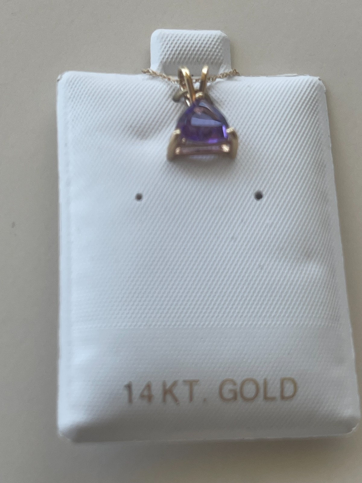 AMETHYST PENDANT, trianglular stone, 14kt gold mount and 18″ gold chain