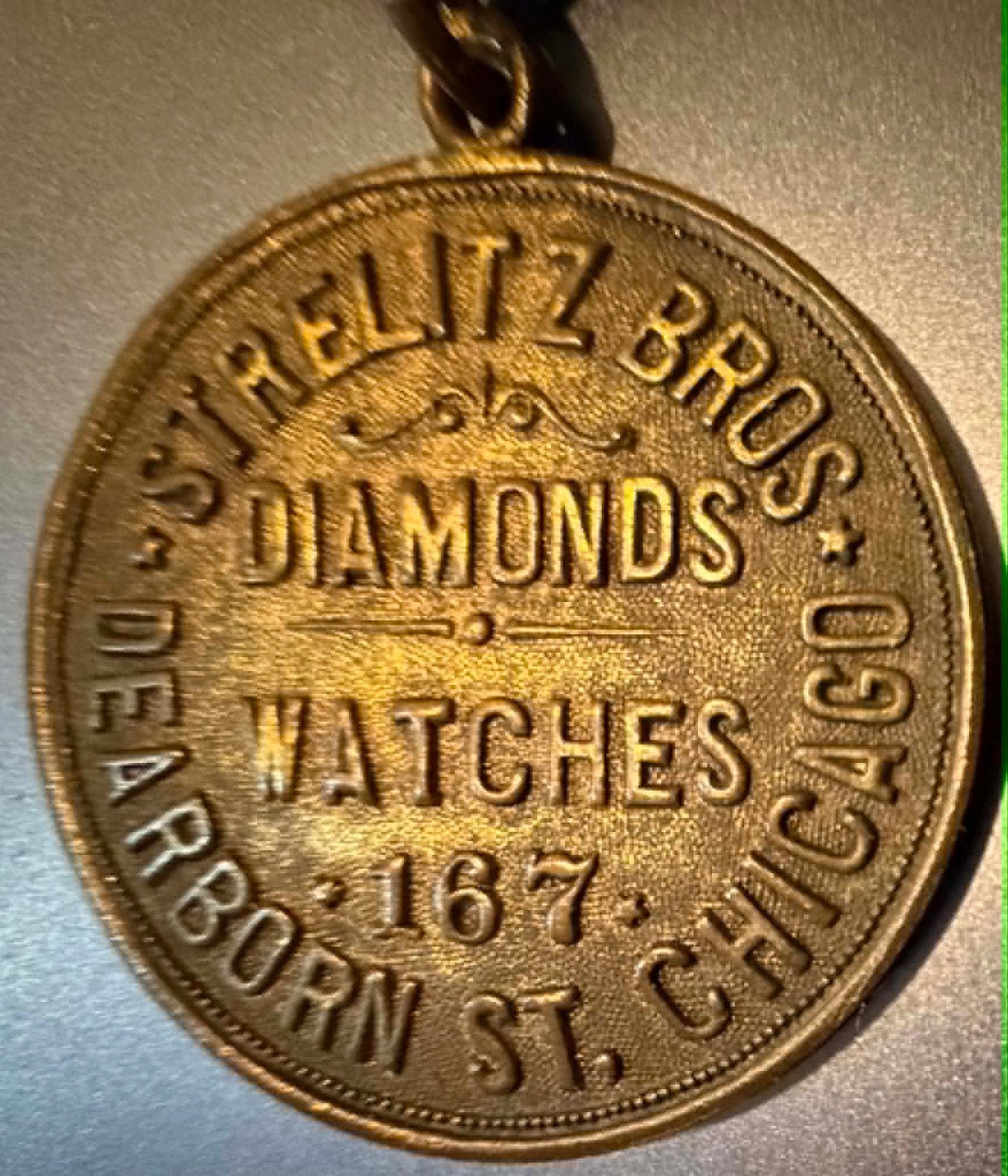 Watch fob: RARE STRELITZ BROS ad on 1906-8 Egyptian Sears watch fob (Lot #291)