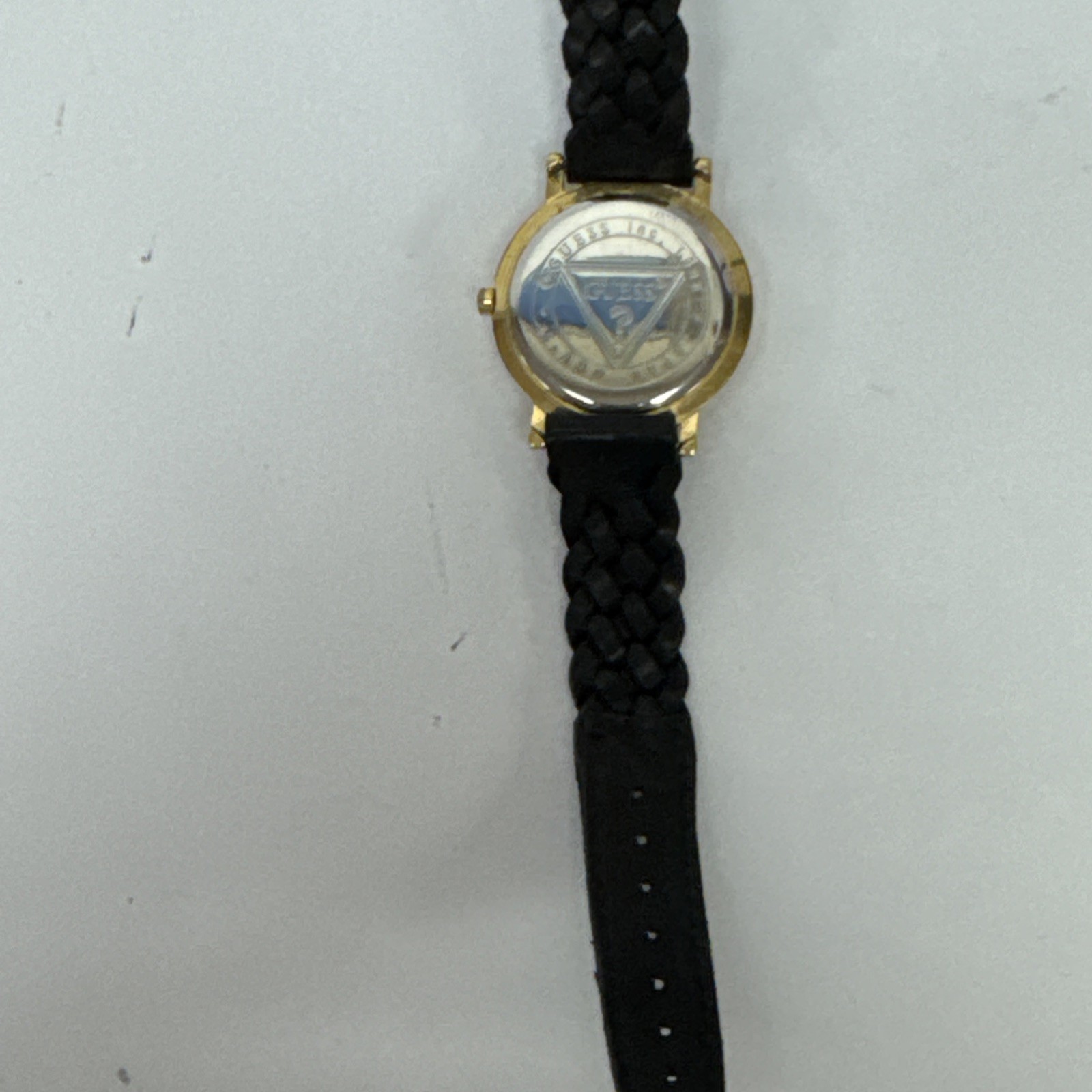 Vtg Guess watch gold-tone & raised 3D numbers and a black braided leather band.