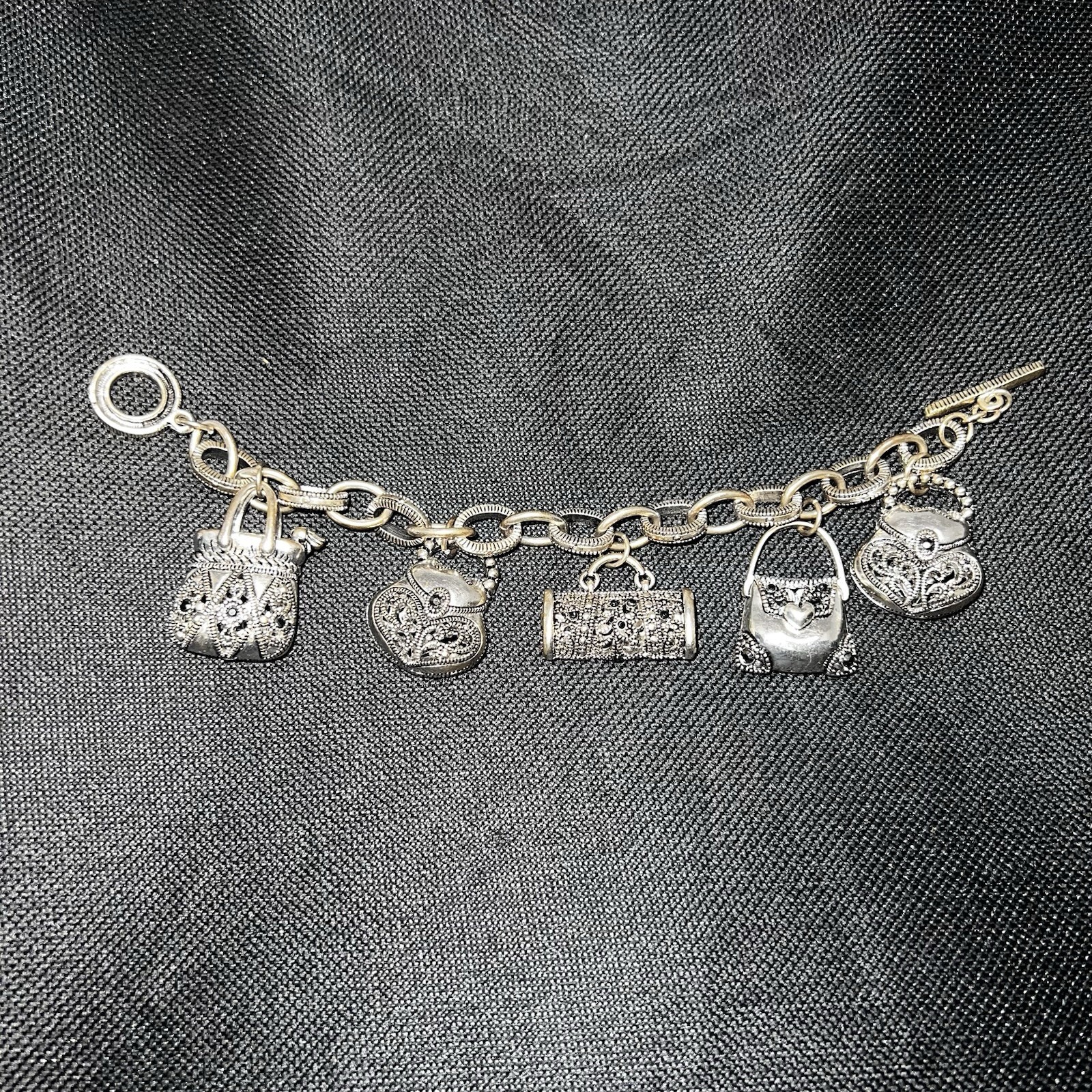 Silver-Tone Metal Puffy Openwork Purse Rhinestone Accent Charm Bracelet toggle