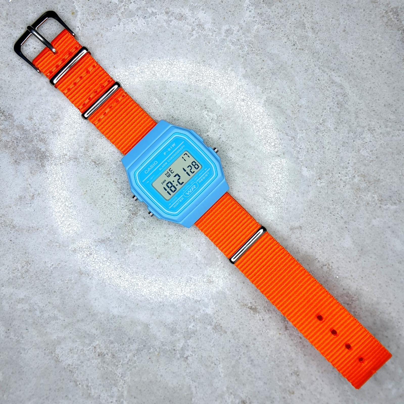 Casio F-91 Watch (Light Blue) on an Orange nylon wrap-around Strap, F-91WC-2AEF